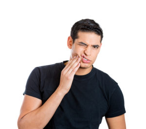 man experiencing oral pain from a dental problem