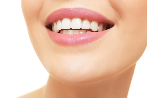 Smiling young woman on white background, closeup